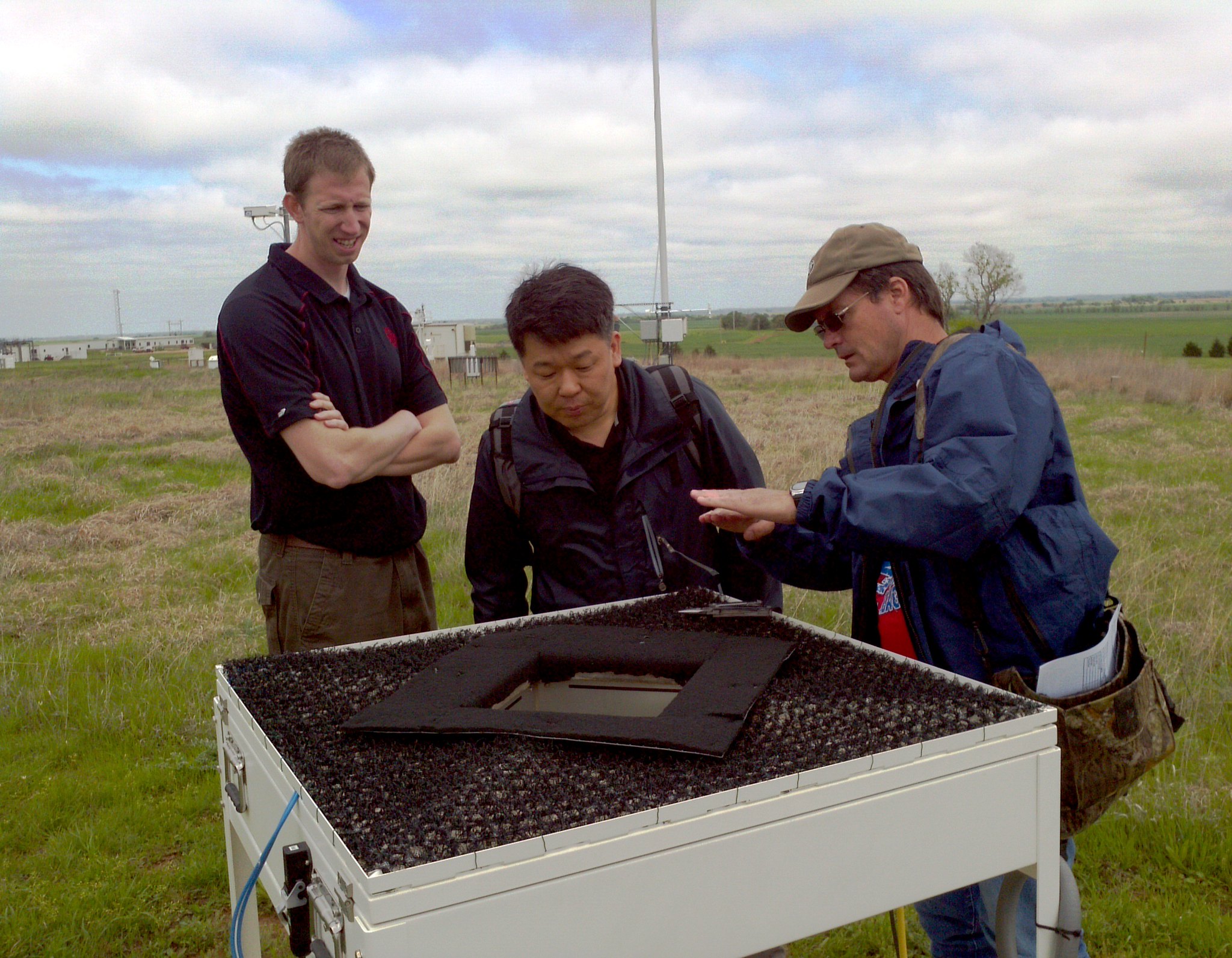 Pat Dowell explains the type of data collected by the video disdrometer as 3 people look at it.
