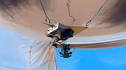 A zoomed-in picture of a camera platform connected to a tethered balloon