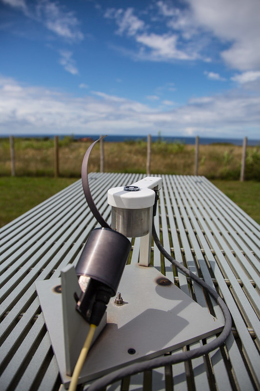 Under a partly cloudy sky, a multifilter rotating shadowband radiometer operates on top of a platform at the Eastern North Atlantic observatory.