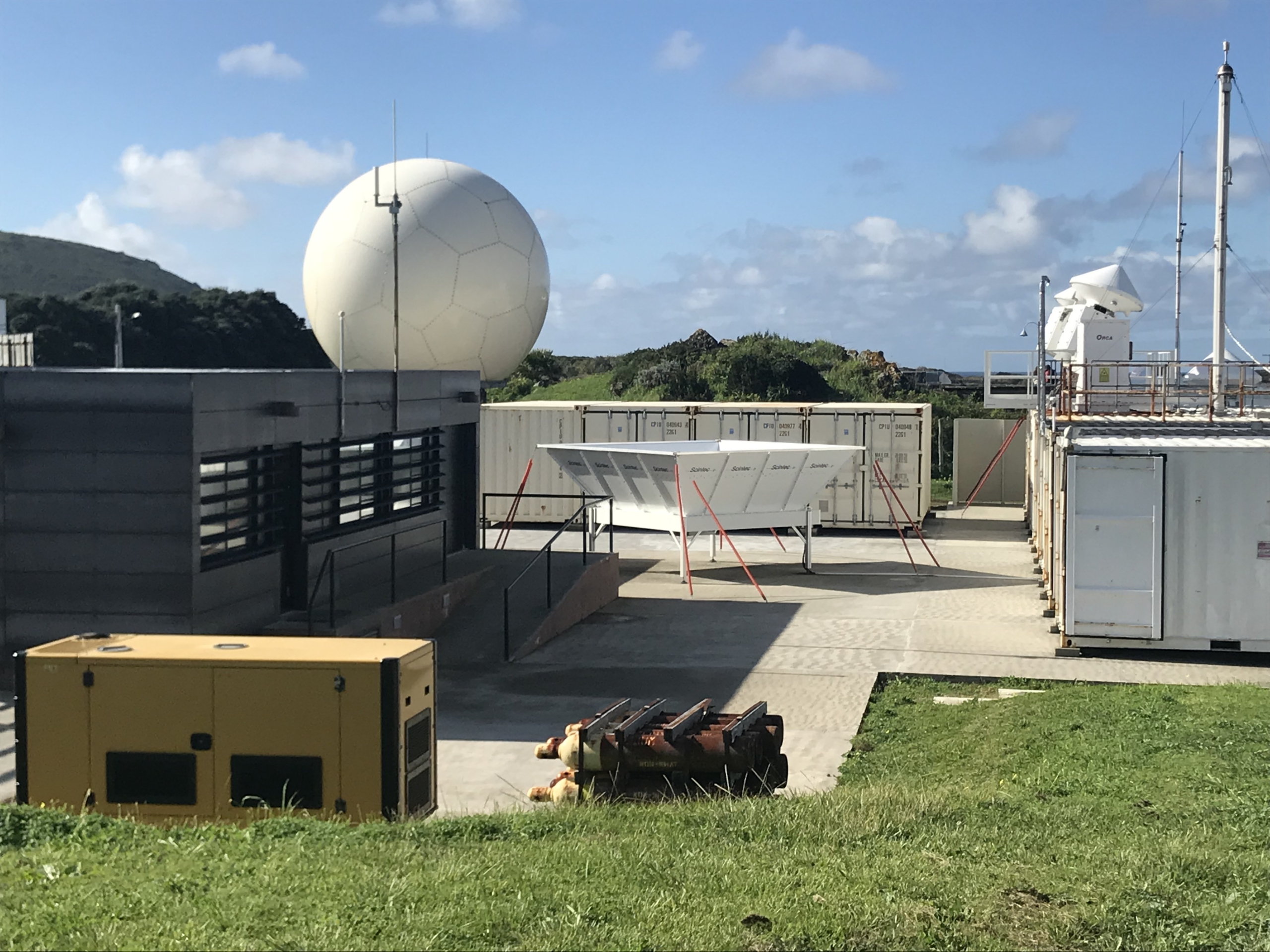 An office building, radars, and an Aerosol Observing System are visible around the Eastern North Atlantic observatory.