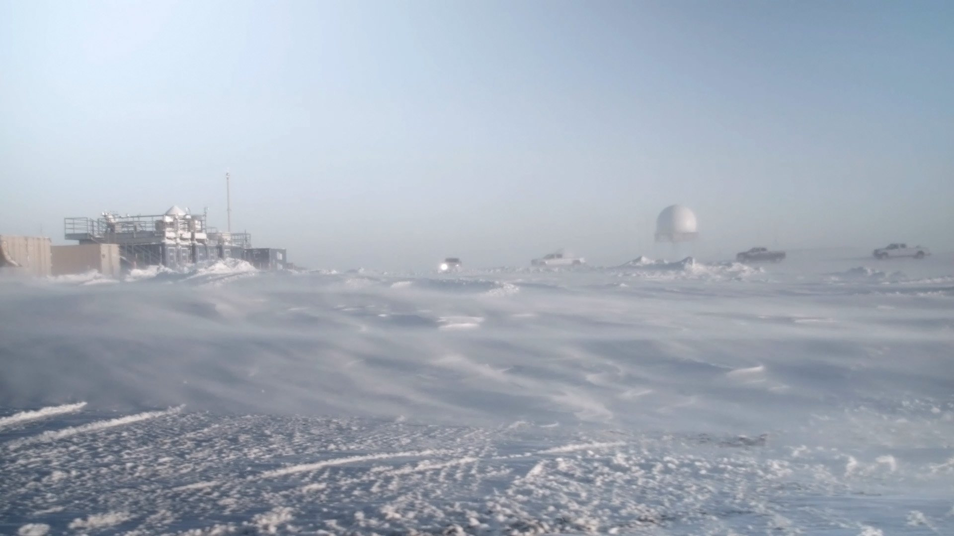 Snow swirls around in front of the ARM Mobile Facility at Oliktok Point.