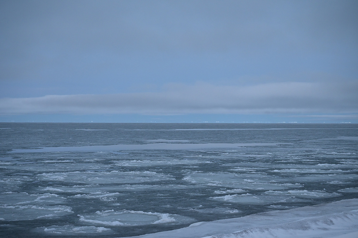 Patchy ice and open water are seen on a cloudy day.
