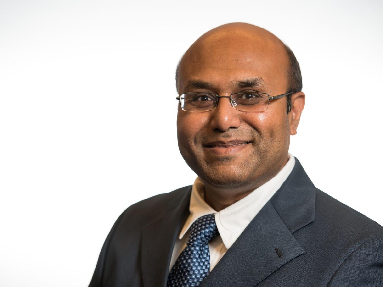 Manish Shrivastava is pictured in front of a white background.