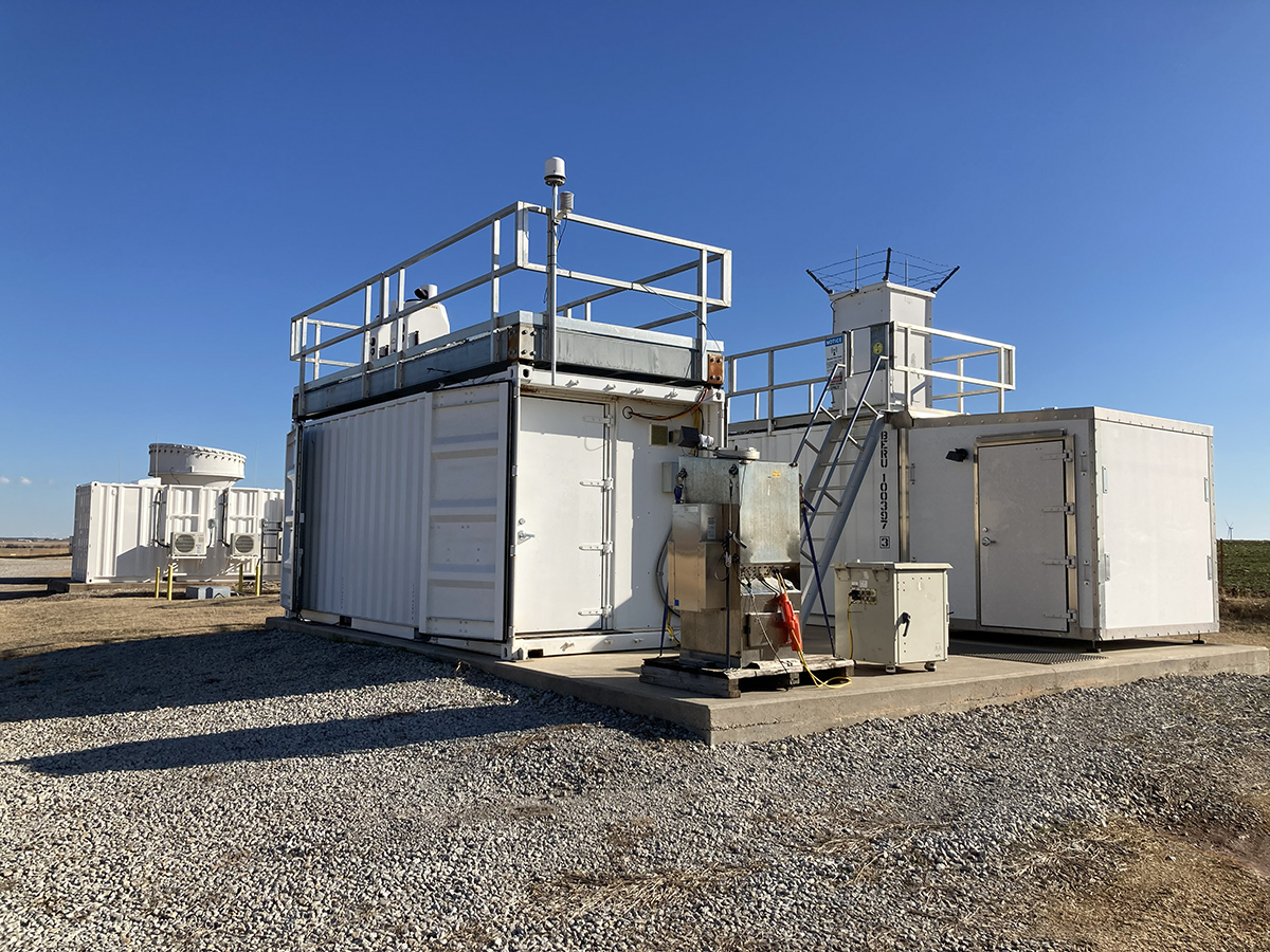 A set of lidars and instrument containers at ARM's Southern Great Plains atmospheric observatory, with a radar seen off to the left