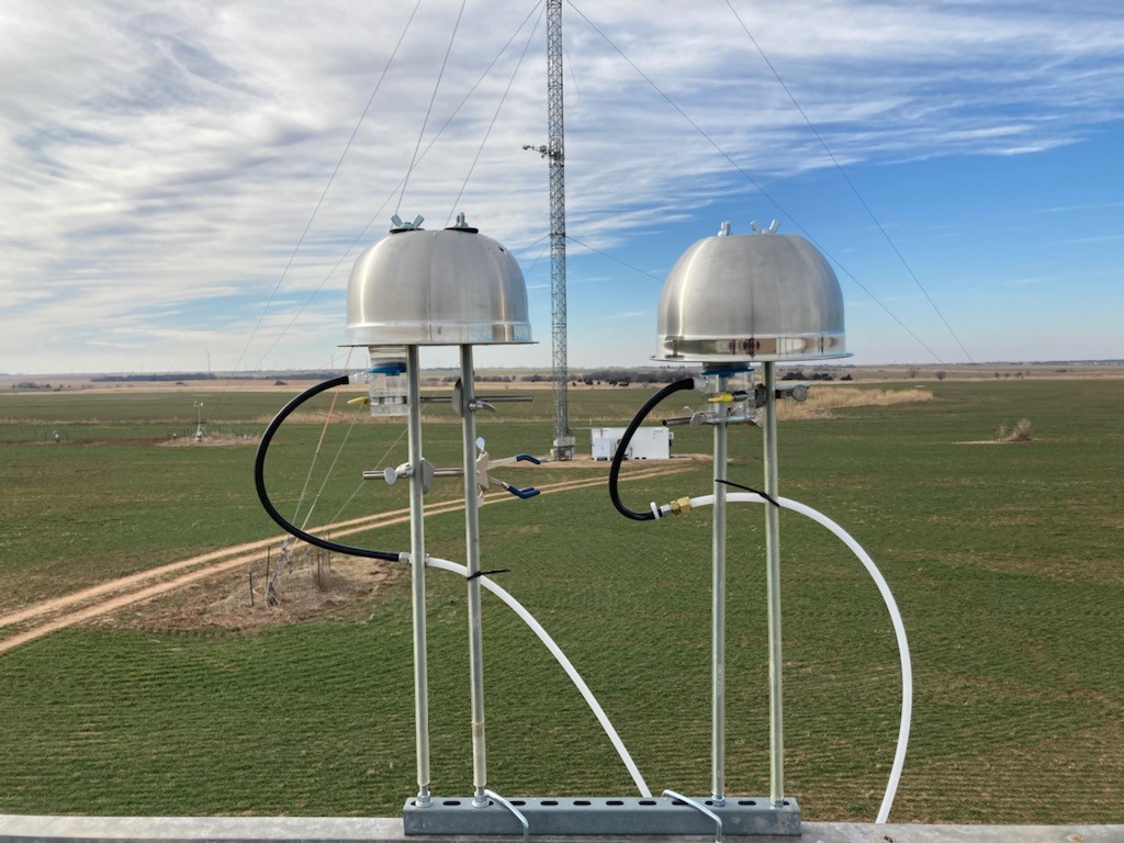 An ice nucleation spectrometer operates at the Southern Great Plains atmospheric observatory on a partly cloudy day.