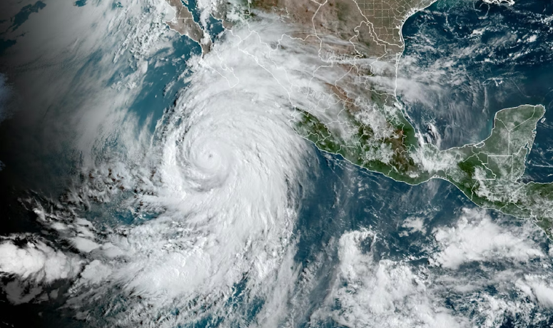 Satellite image of hurricane off west coast of Mexico, with the northern portion of the storm hitting Baja California